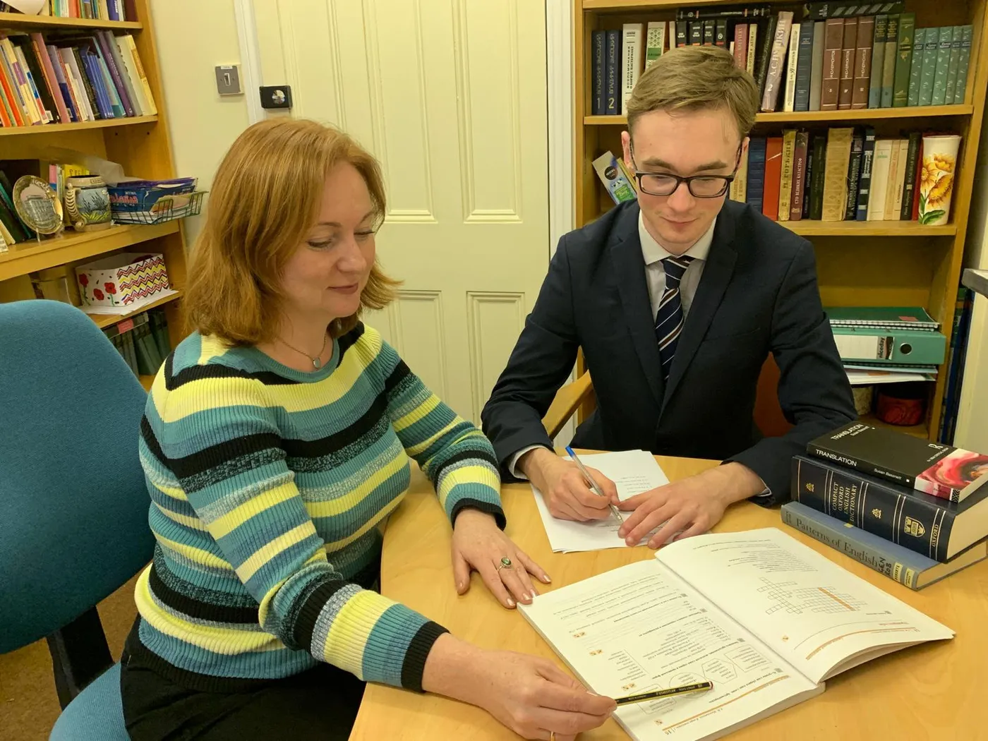 A student working through an English lesson with a tutor