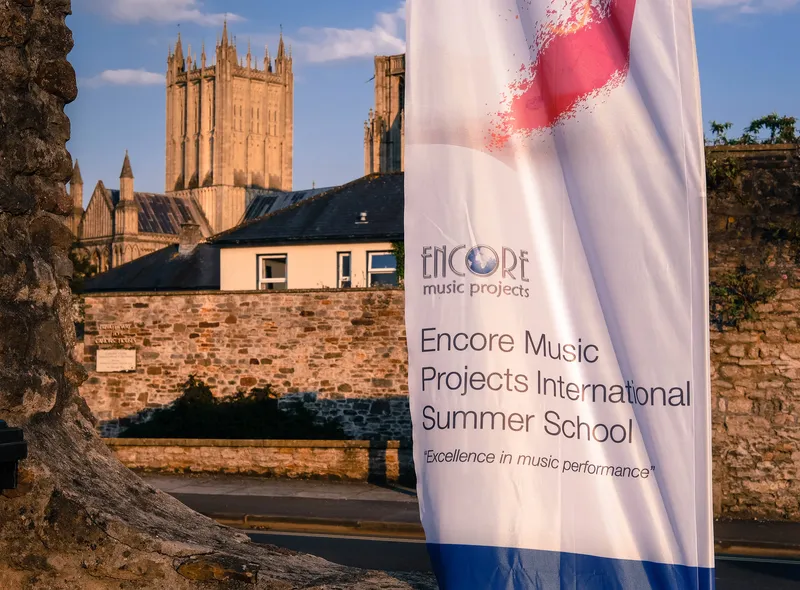Wells Cathedral seen from the city walls, with an Encore Music Projects banner