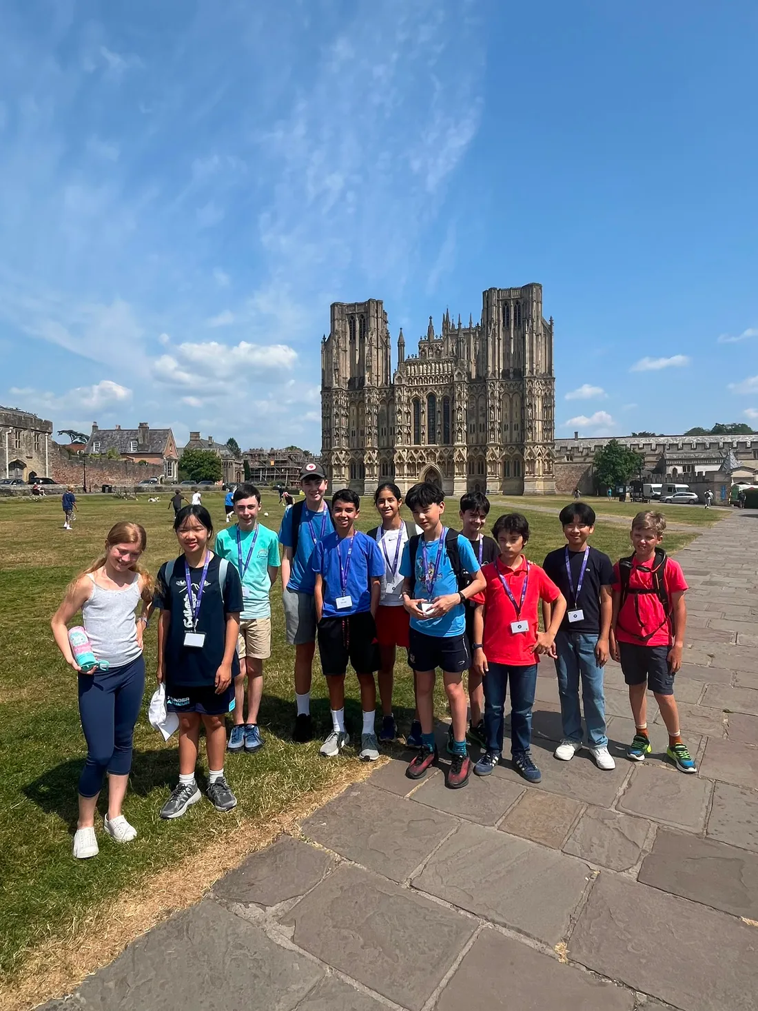 The full group of students together on the green outside Wells Cathedral