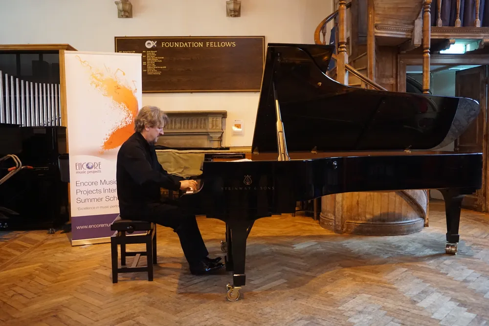 A faculty pianist performing a solo recital in Quilter Hall
