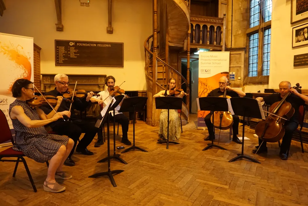 A faculty string sextet performing in Quilter Hall
